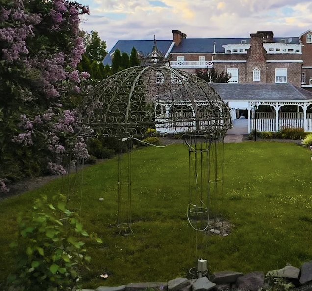 The iron garden gazebo on the Mimslyn's lawns with the inn and pavilion behind